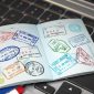 passport with visa stamps with airline boarding pass tickets and stamper 85x85